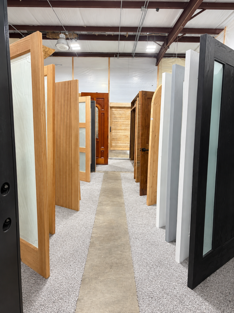 Rows of wood and modern interior door samples displayed in the showroom