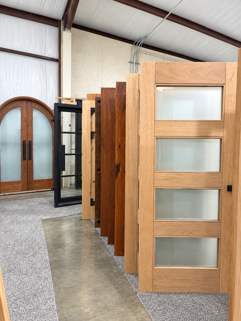 Natural wood and frosted glass door styles displayed at the Texas Doors & Windows showroom